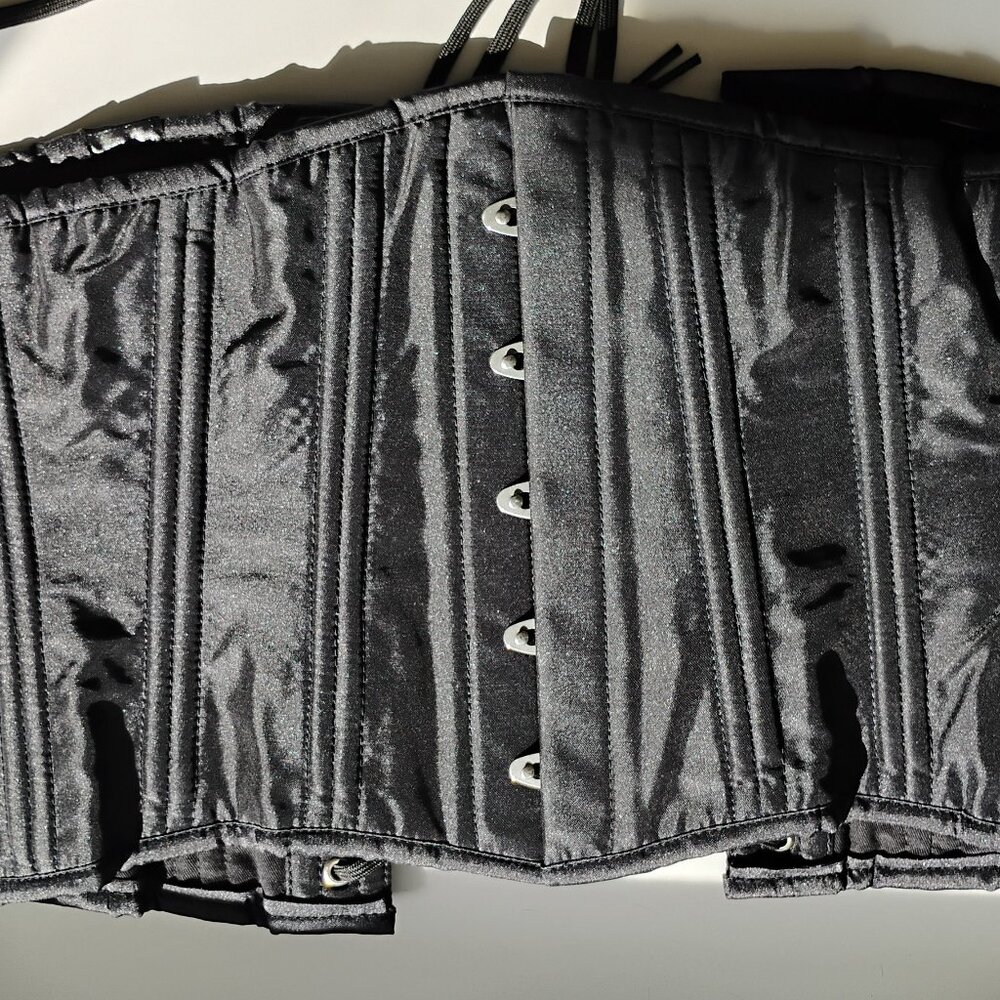 Plain black cotton corset with metal boning and modesty panel.